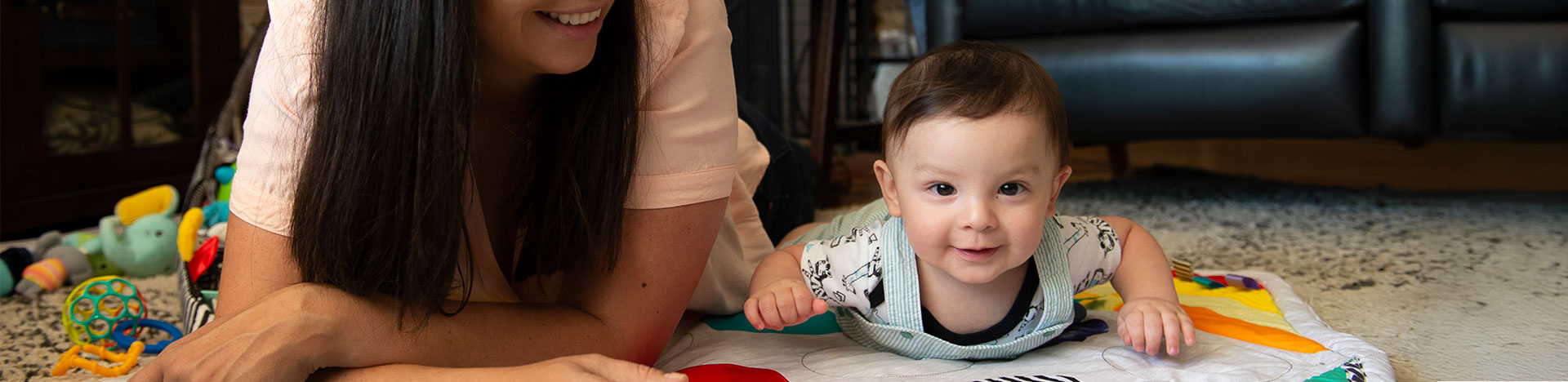 Baby on a playmat with their mom