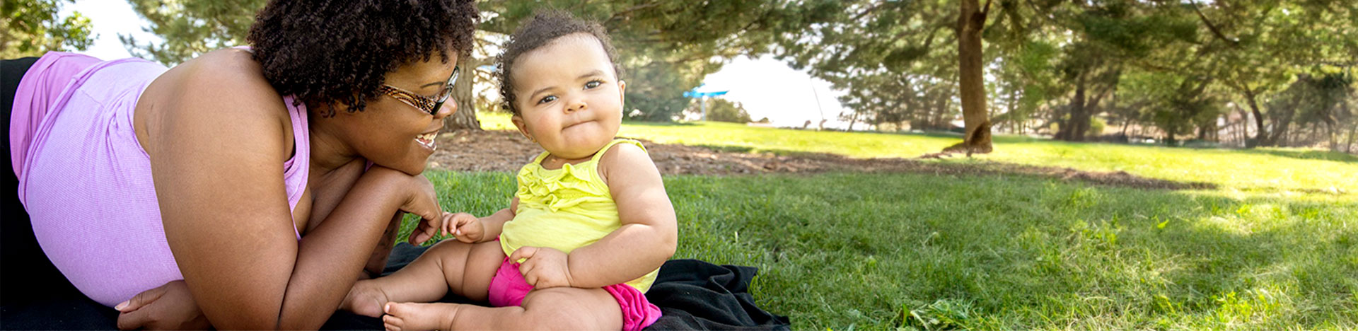 a mother and baby at a park